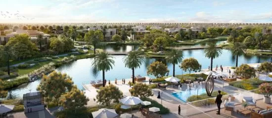 Serene lagoon with crystal-clean water surrounded by lush greenery at The Acres, Dubai.